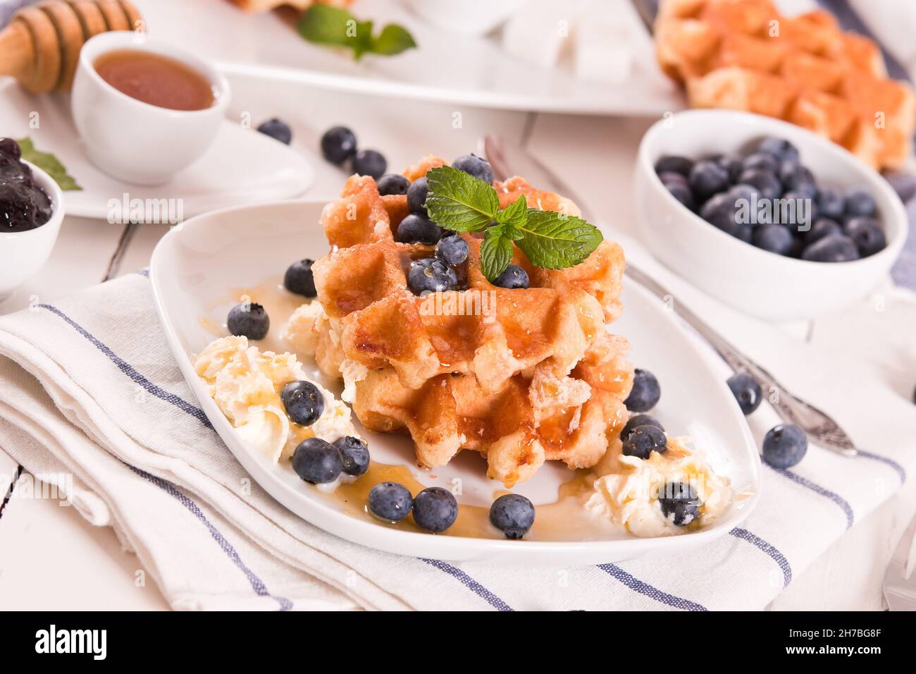 Waffles with blueberries and whipped cream Stock Photo - Alamy