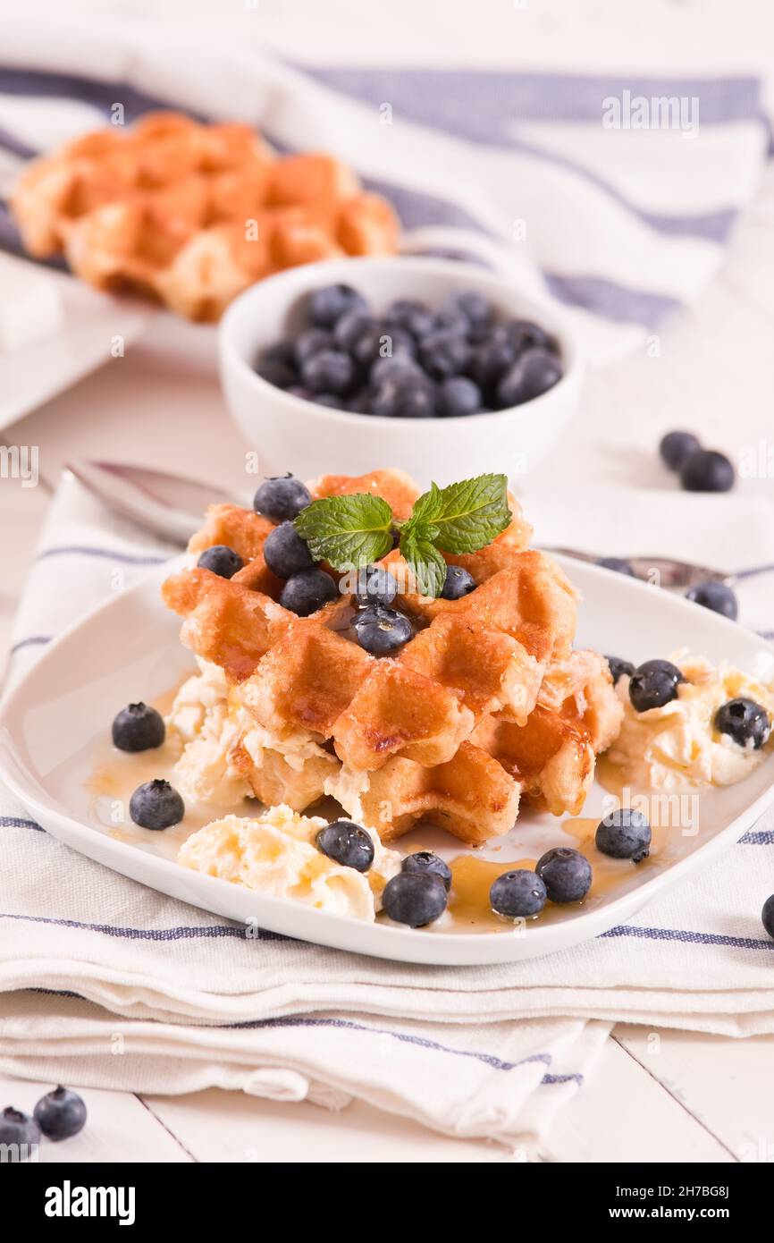 Waffles with blueberries and whipped cream Stock Photo - Alamy