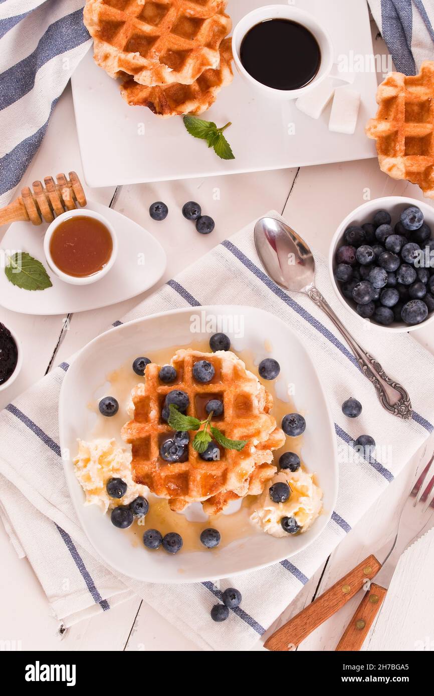 Waffles with blueberries and whipped cream Stock Photo - Alamy