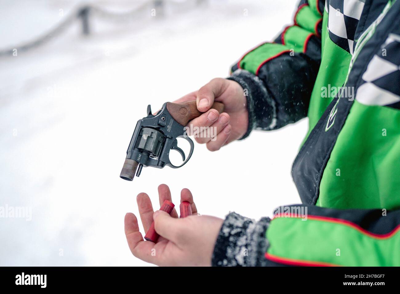 Simon Barbour loads his starter pistol to scare off bears during a