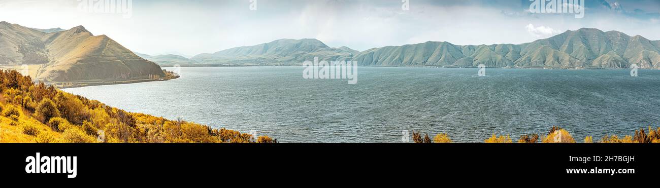 Panoramic view of famous Sevan lake with bald mountain ranges. Dramatic and harsh northern landscape. Tourist attractions in Armenia Stock Photo
