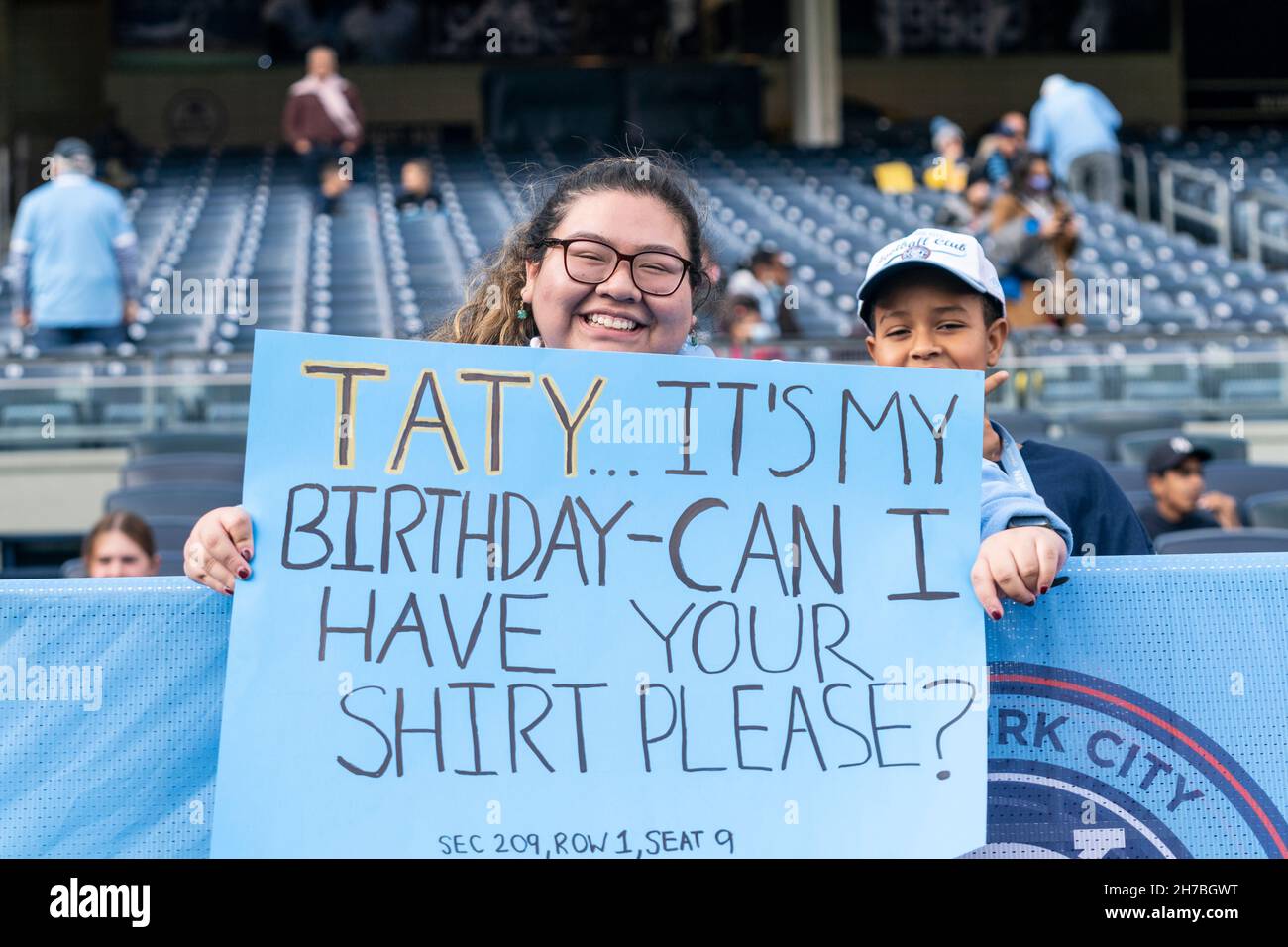 New York, NY - November 21, 2021: Carolyn Seminario from Queens is fan of NYCFC since 2017, came to Yankee stadium on her birthday to cheer the team and is displaying sign asking Valentin Castellanos for his jersey during first round game of MLS Cup versus Atlanta United on Yankee stadium Stock Photo