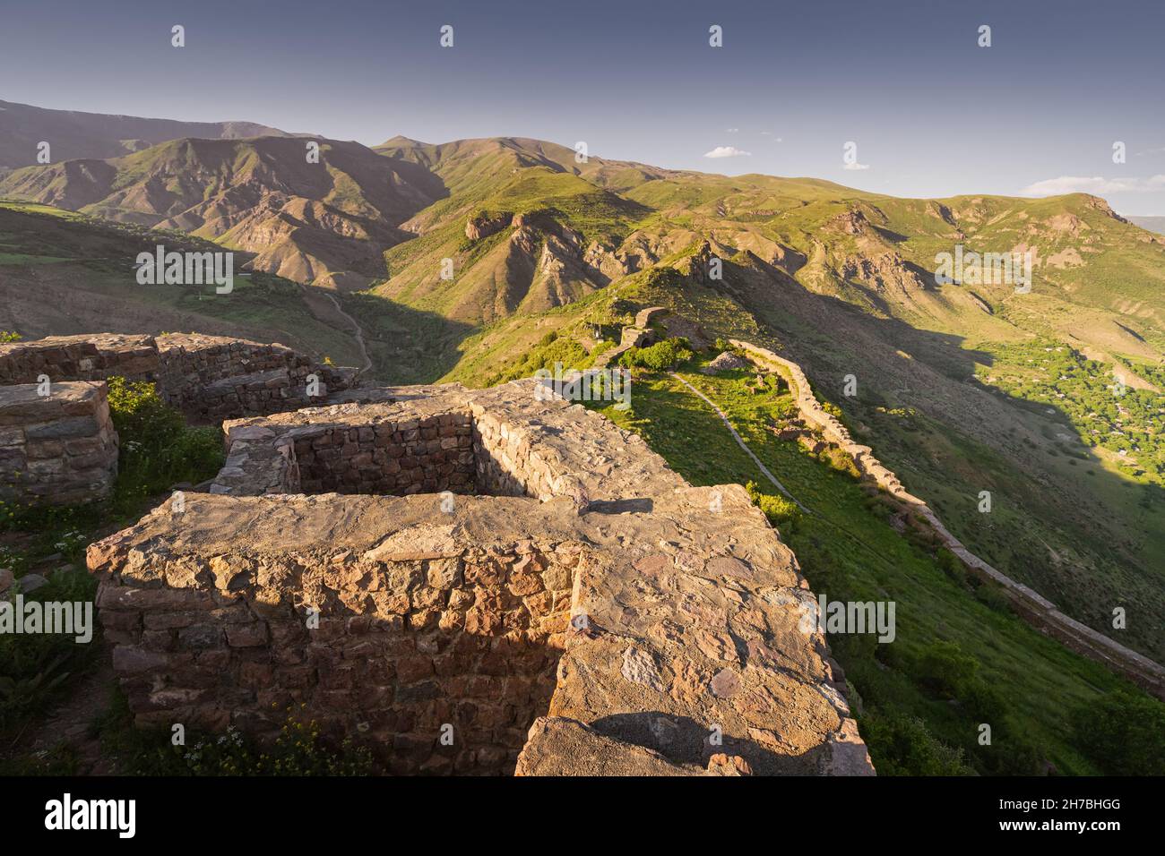 Panoramic view of the famous Smbataberd fortress in the Armenian Transcaucasia with gorgeous views of mountain valleys at golden sunset light Stock Photo