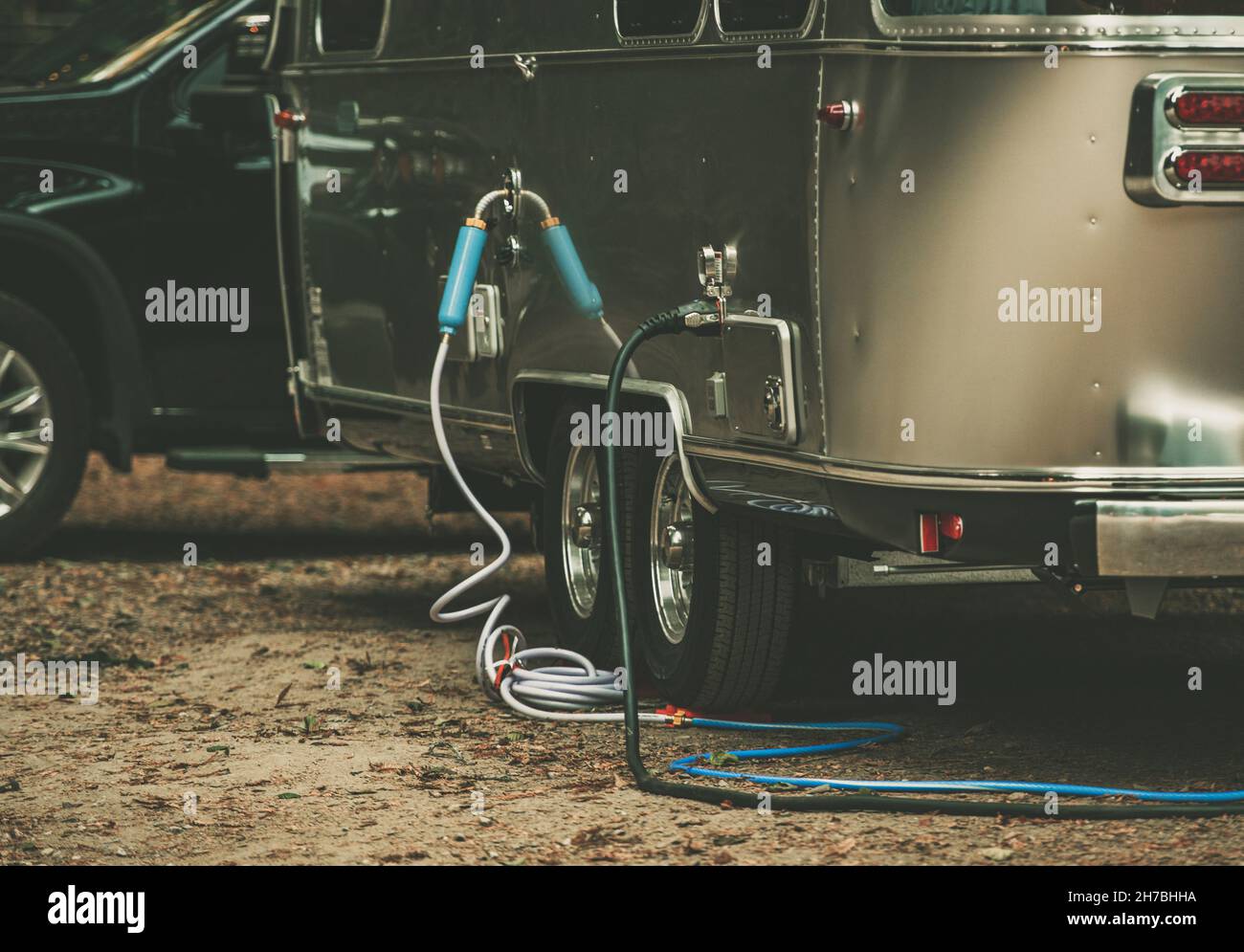 RV Park Full Hookups. Travel Trailer Connected to Water and Power