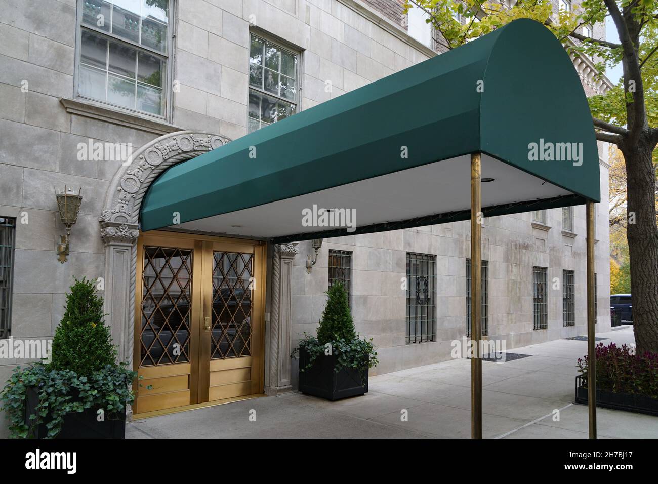 Manhattan elegant upscale apartment building and awning leading from front door to street Stock Photo