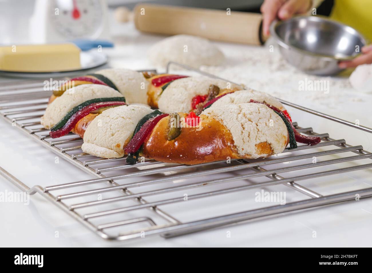 mexican woman baking a traditional rosca de reyes or epiphany cake on the oven in kitchen at home for Kings Day in Mexico Latin America Stock Photo