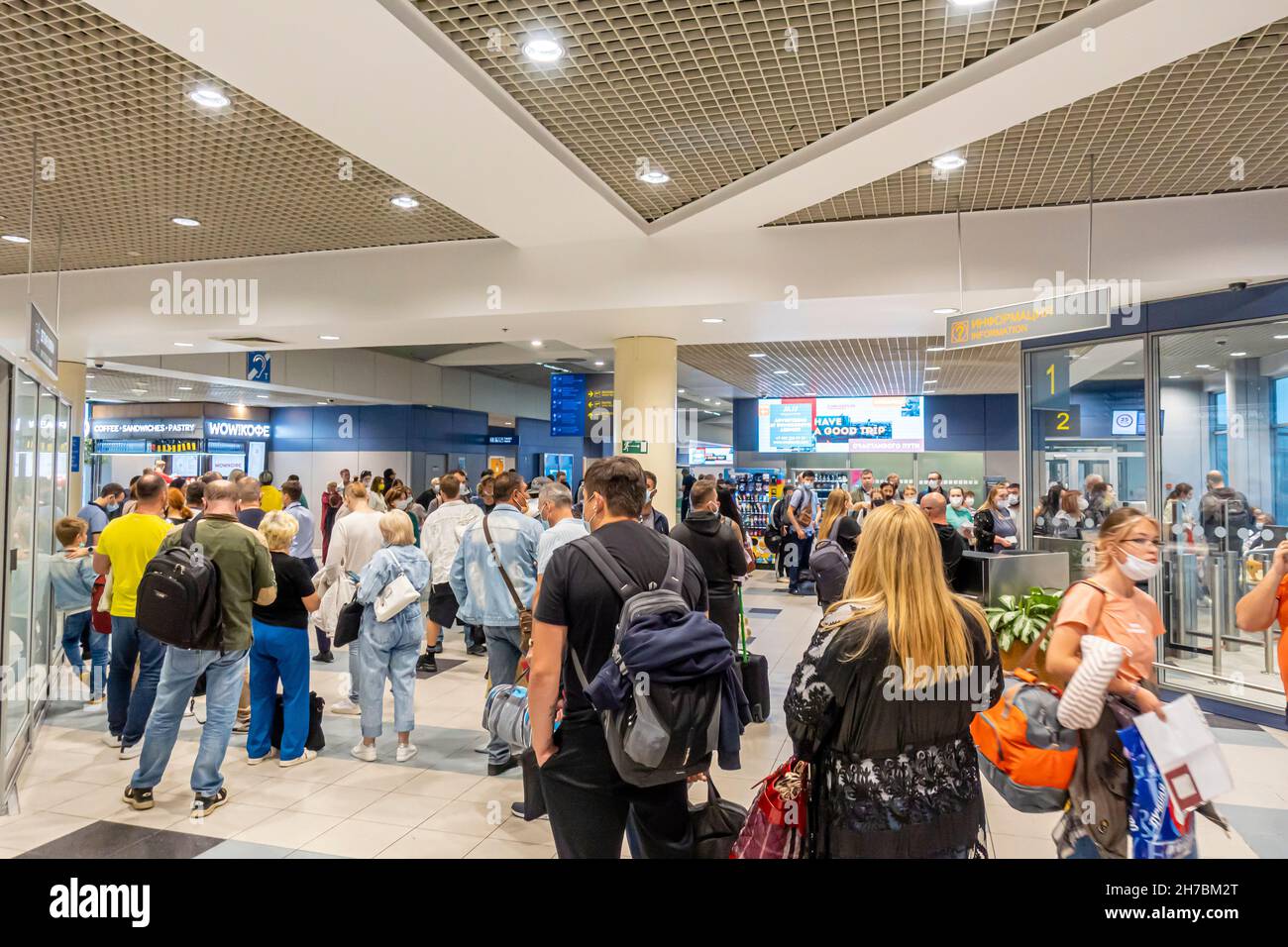 Passengers in face masks in queuee at the Gate 1A to board on the flight in Domodedovo Airport, DME, Moscow, Russia Stock Photo