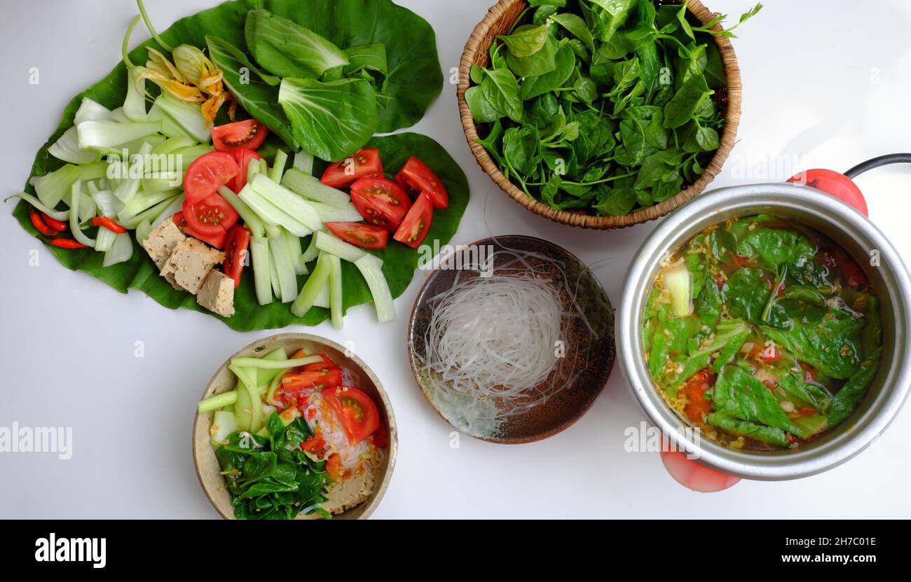 Vietnamese green vegetables hot pot, tomato, bok choy, tofu skin, colocasia gigantea with