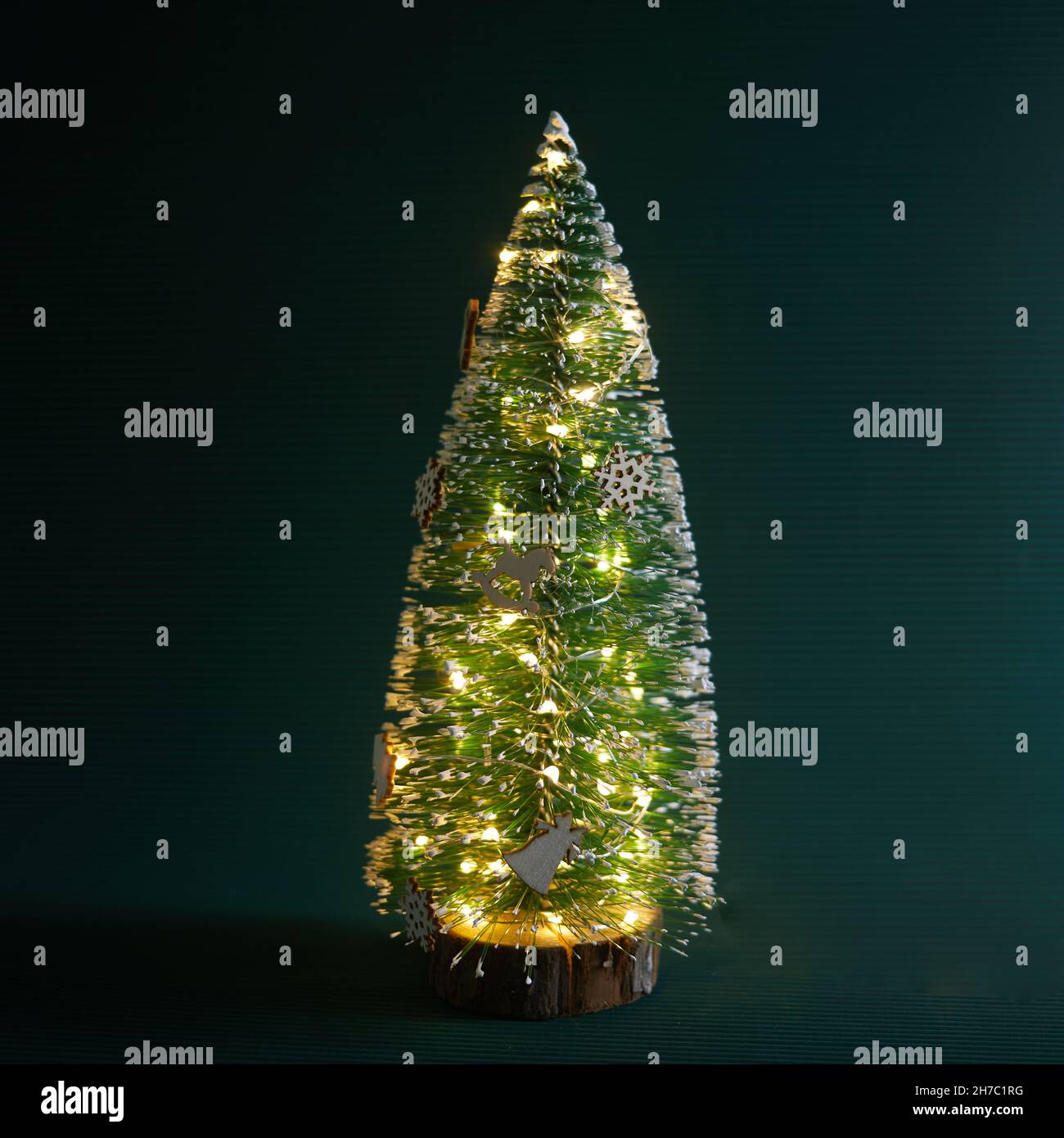 Deccorated Christmas tree on green background. Space for text Stock Photo