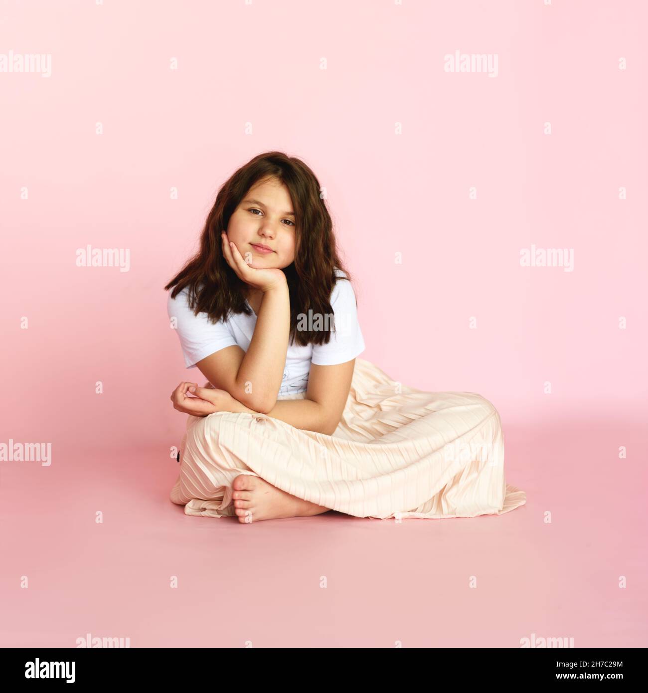 Studio portrait of young girl on pink background. Stock Photo