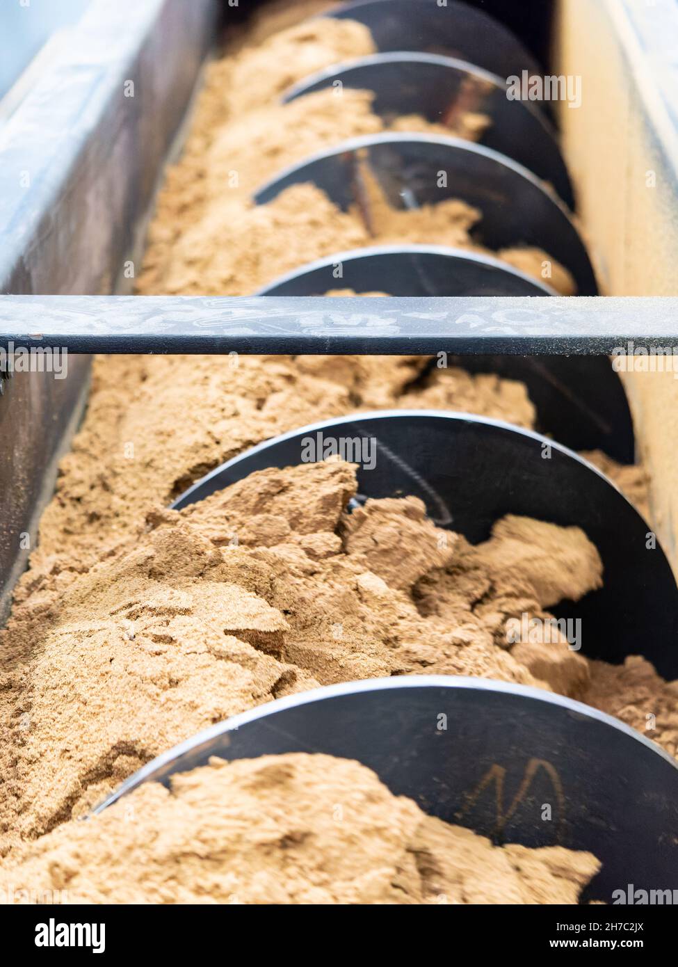 Screw conveyor with chicken meal, a protein rich meal that is made from