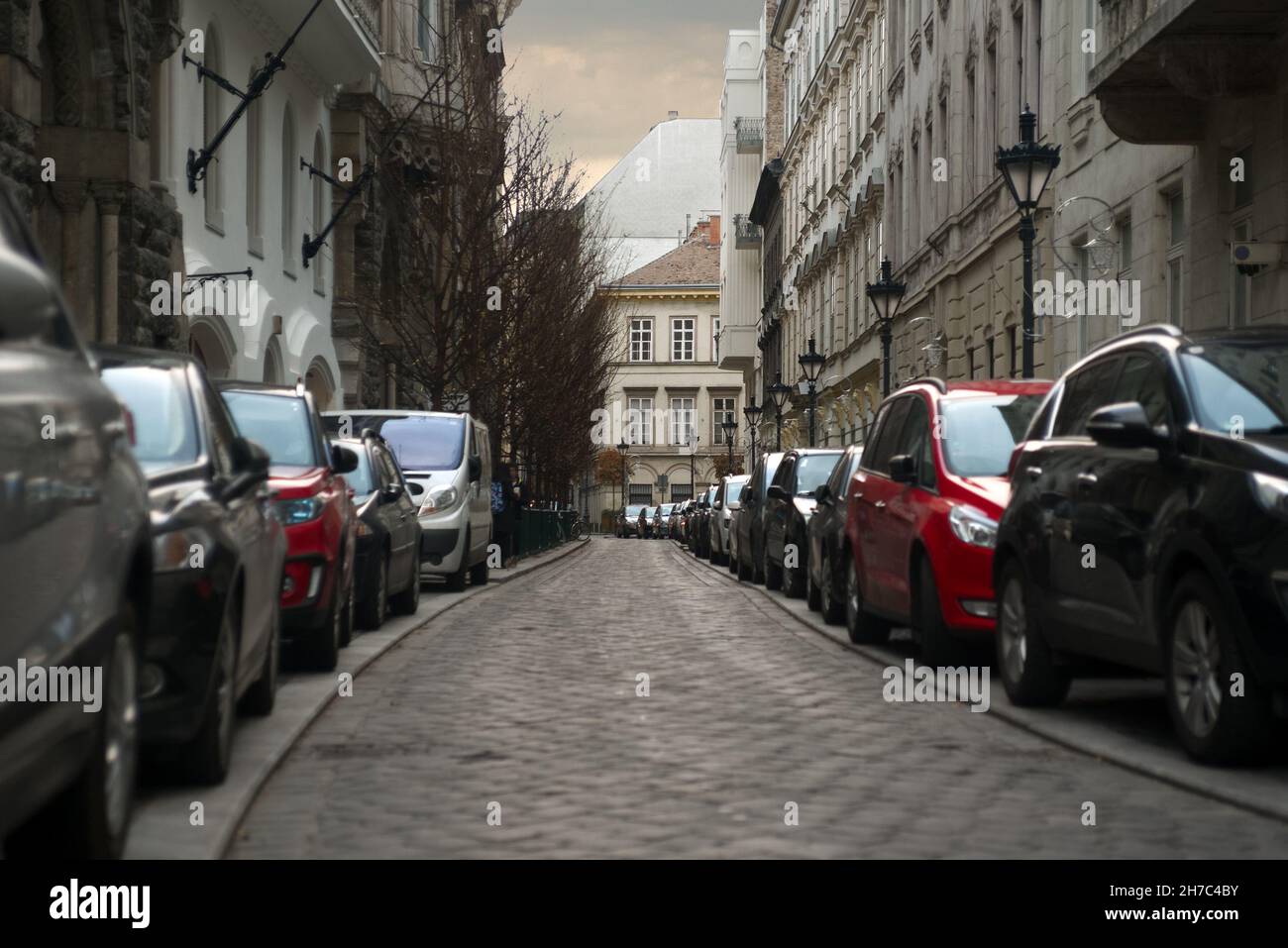 Cars parked in line on both sides of Veres Pálné streetin Budapest Stock Photo