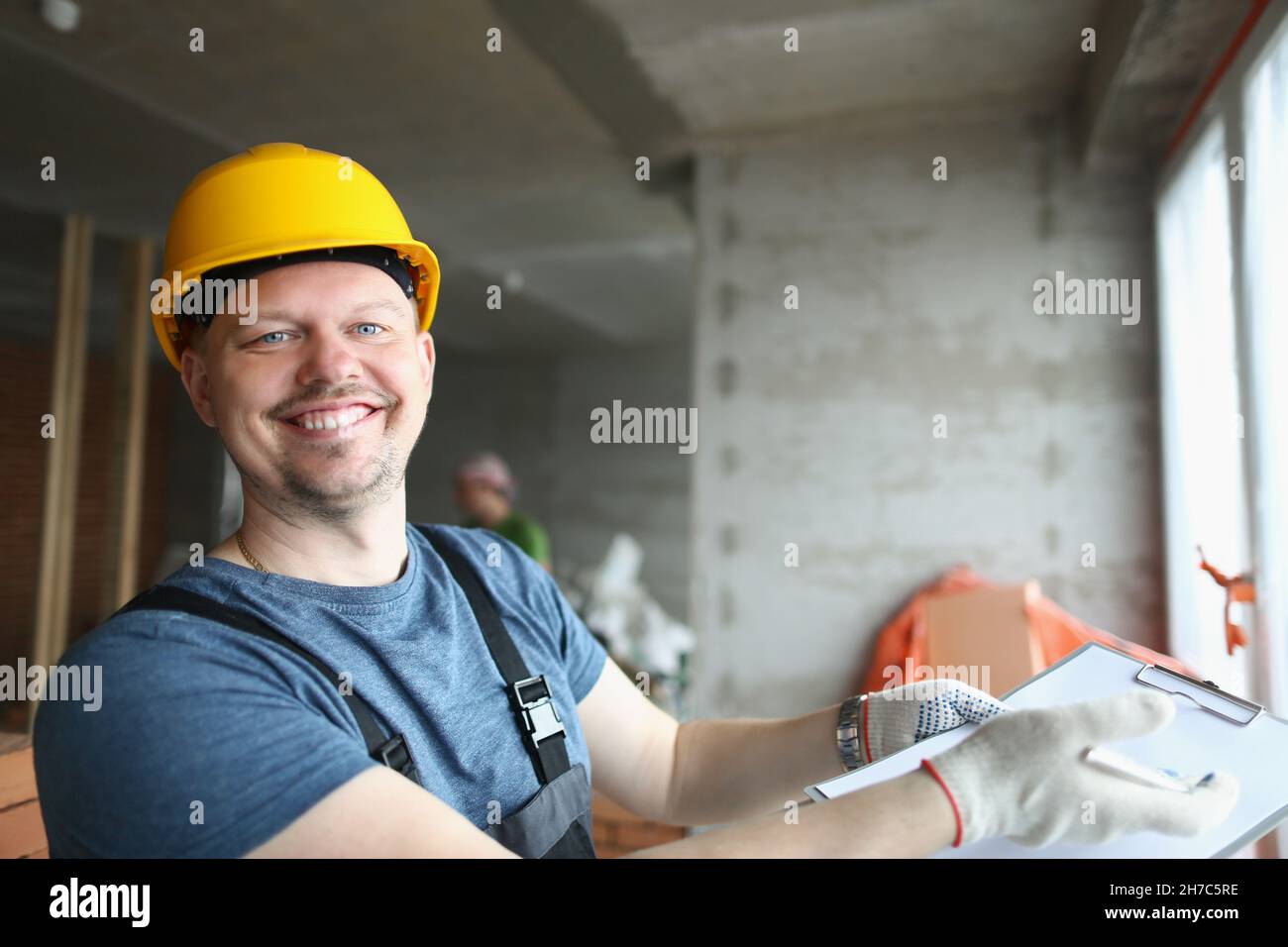 Smiling professional worker hold clipboard with document on house purchase Stock Photo