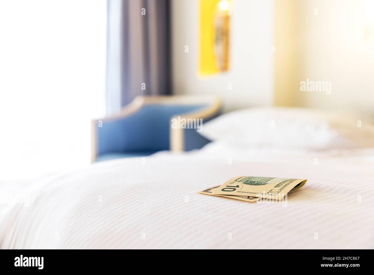 Traditional tips is laying on the corner of bed in hotel room for room