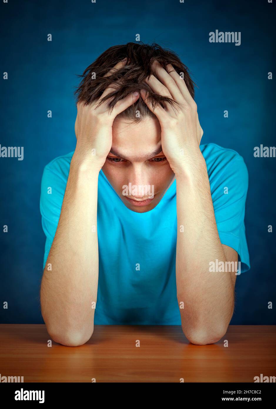 Sad Young Man Portrait on the Blue Background Stock Photo - Alamy