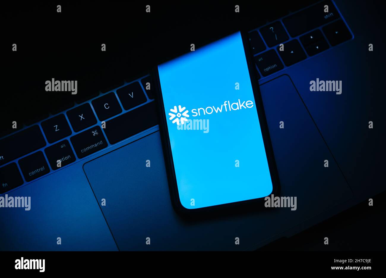 Snowflake logo on smartphone screen. Stock Photo
