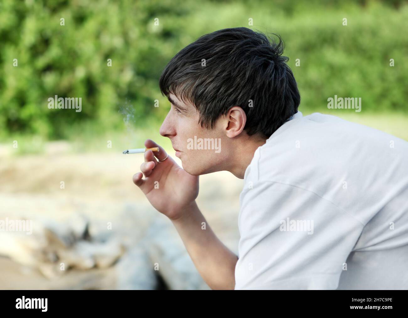 Sad Young Man with Cigarette on the Nature Background Stock Photo Alamy