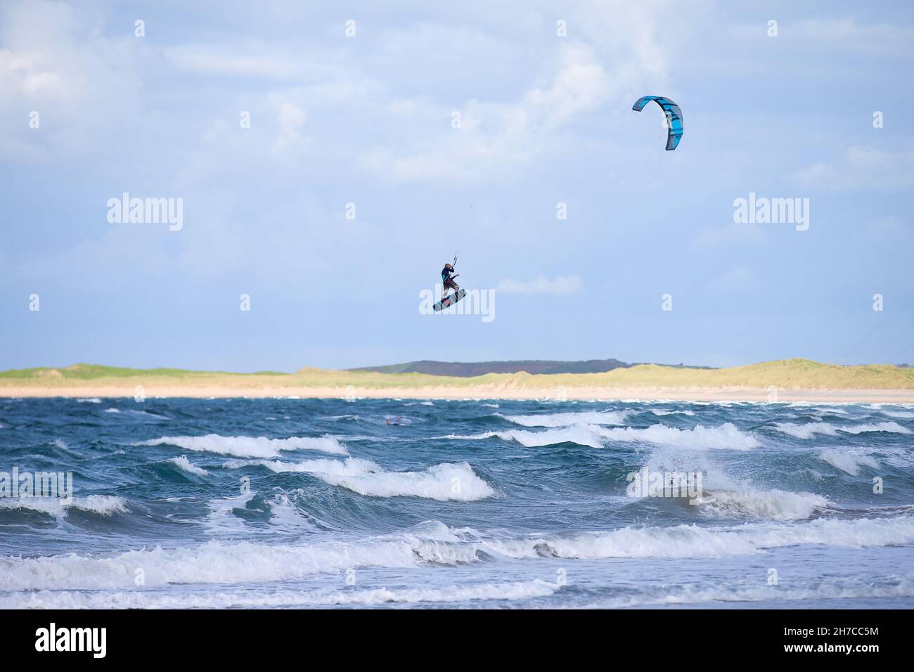 Kite surfers catching air off the Co. Sligo coast in the Atlantic Ocean off Ireland's west coast.  Just some of the fun on the Wild Atlantic Way. Stock Photo