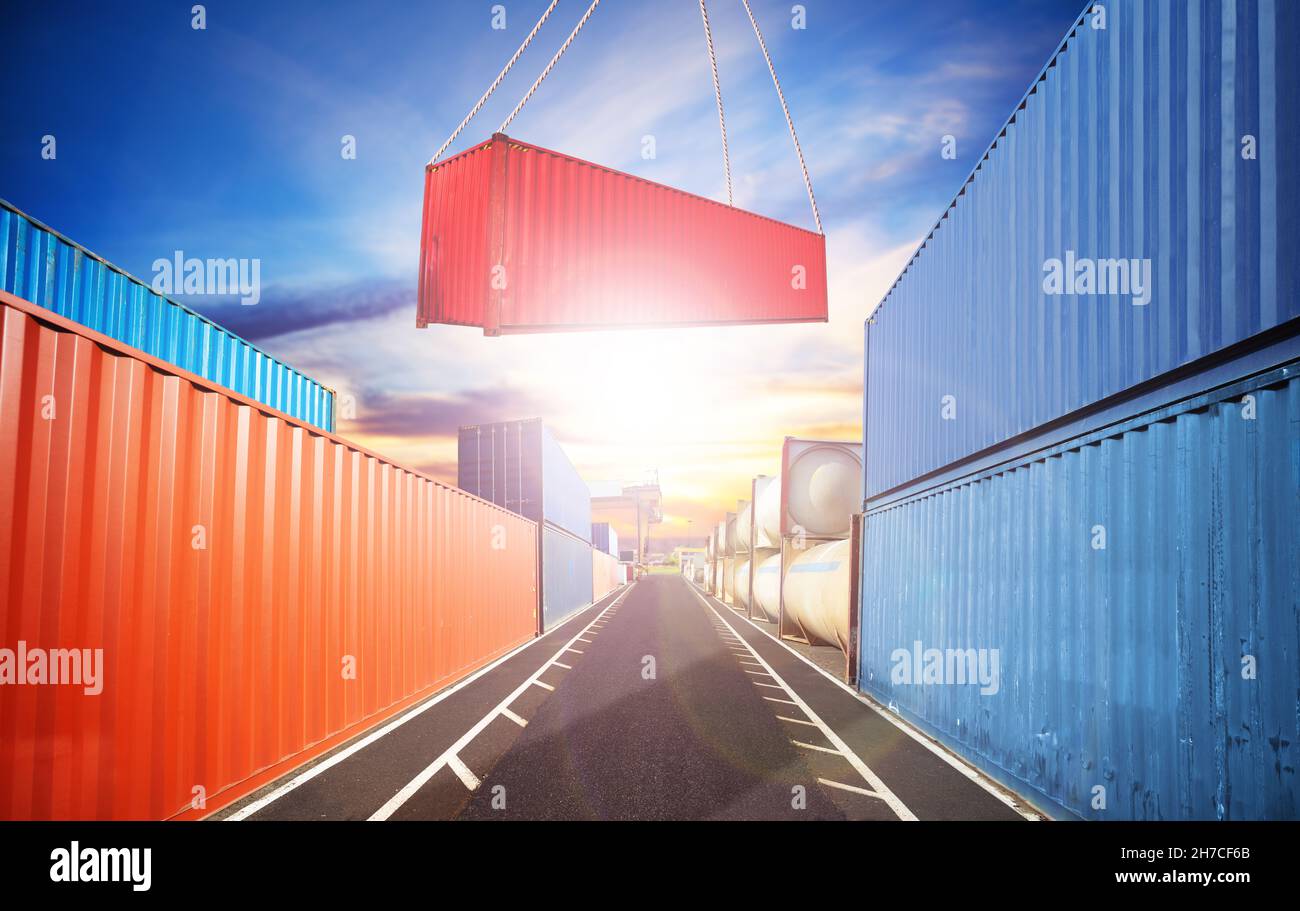 Crane put container in the port view over sunset Stock Photo