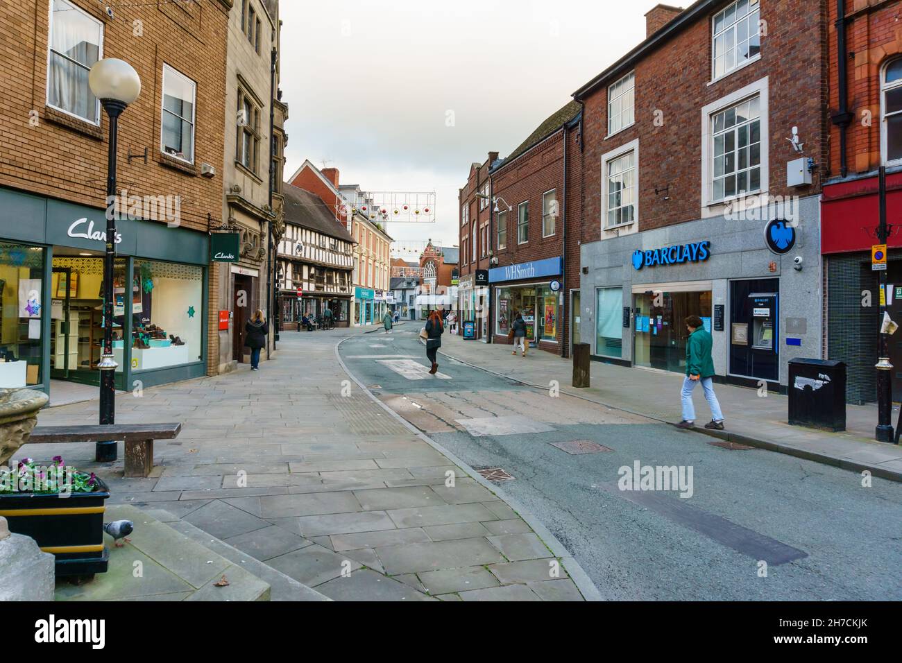 Shops and shoppers on Cross street in the town of Oswestry North Shropshire England Stock Photo