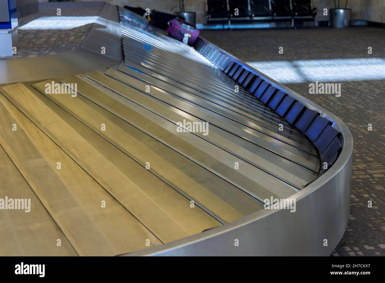 Baggage pickup carousel with on a luggage belt at the airport Stock Photo