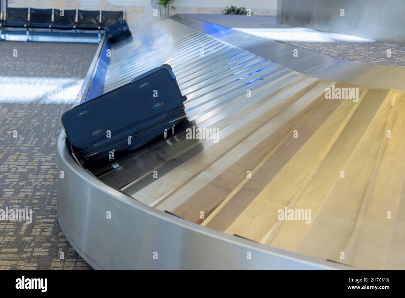 Carousel with luggage at arrival area of passenger terminal Stock Photo