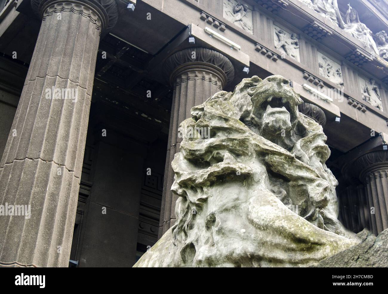 Stone lion statue standing among stone columns Stock Photo Alamy