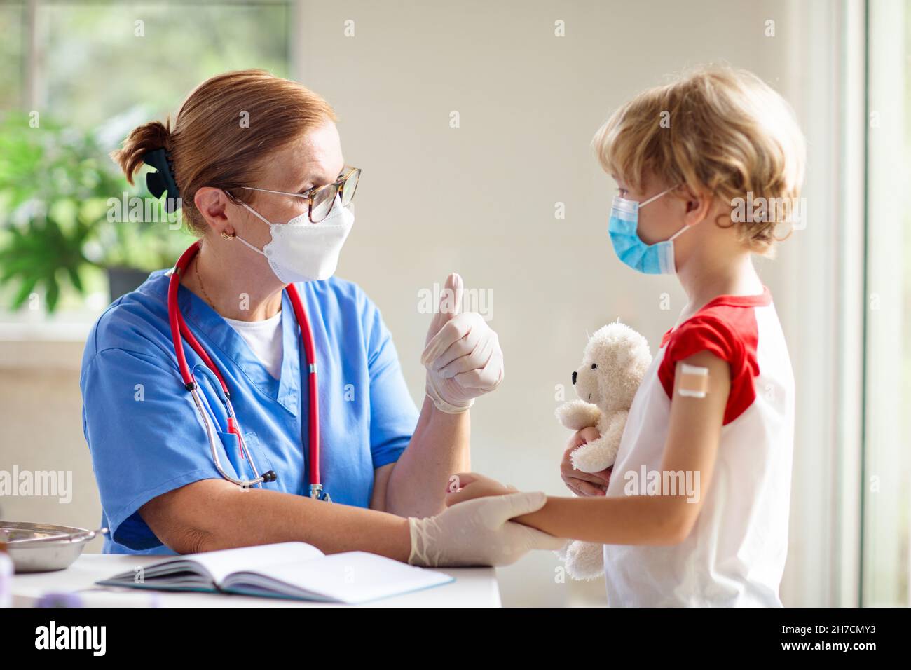 Child getting covid-19 vaccine. Coronavirus vaccination for young kids. Doctor giving kid patient covid shot. Immunization program for adolescents Stock Photo