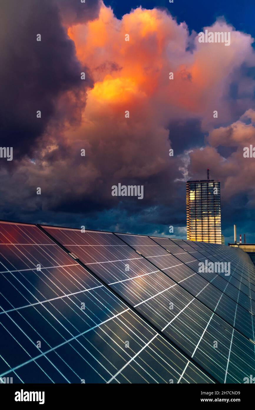 Building roof with solar panels under a cloudy sunset sky in Klaipeda ...