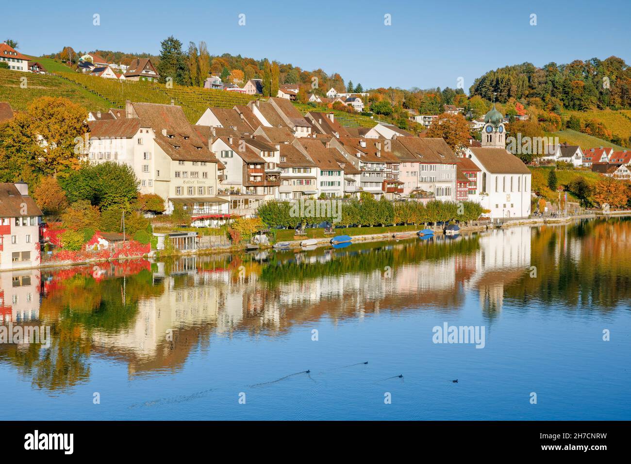 view from the Rhine bridge onto the old town of Eglisau mirroring on the water, Switzerland, Eglisau Stock Photo