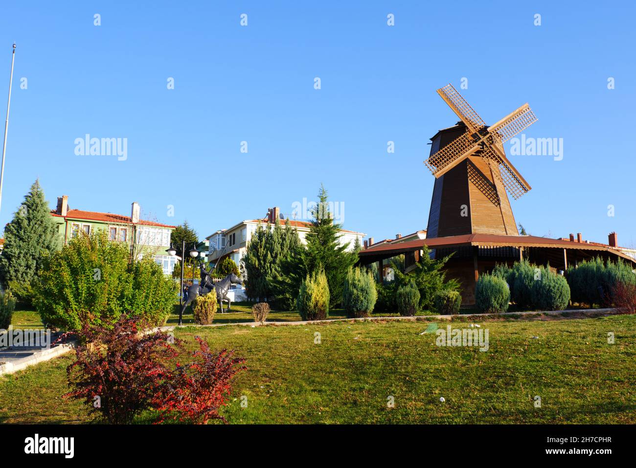 Vintage wooden windmill tower over bushes at Selale Park Eskisehir Turkey Stock Photo