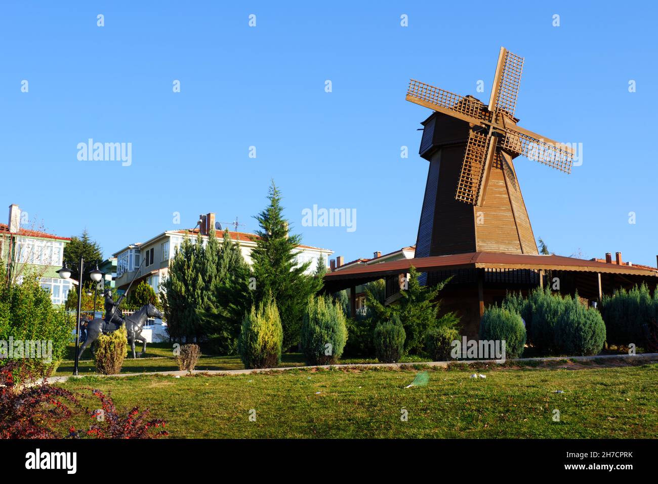 Vintage wooden windmill tower over bushes at Selale Park Eskisehir Turkey Stock Photo