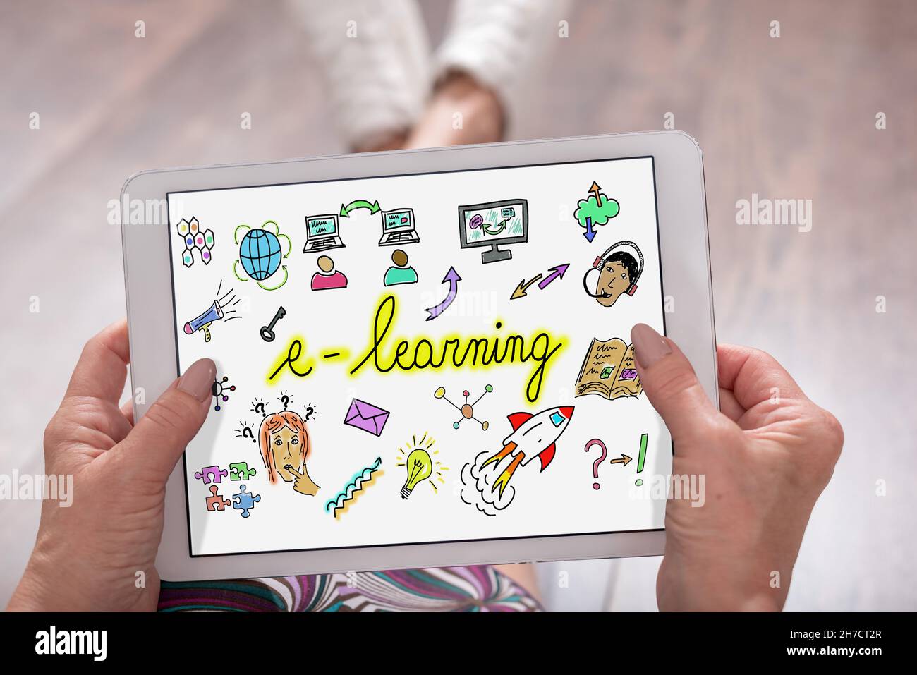 E-learning concept shown on a tablet held by a woman Stock Photo - Alamy