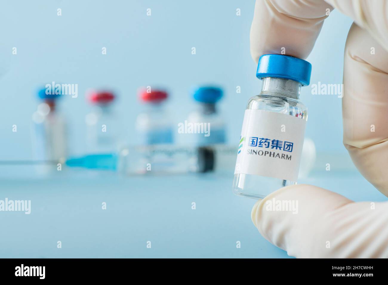Zynapse Injection A vaccination syringe and a glass ampoule with a clear liquid on a blue ...