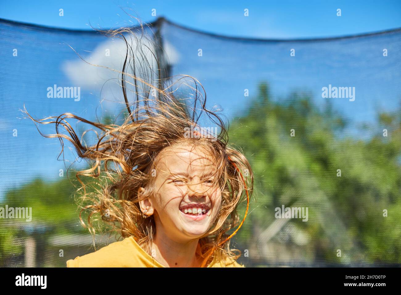 Little girl jumping up and down in hires stock photography and images