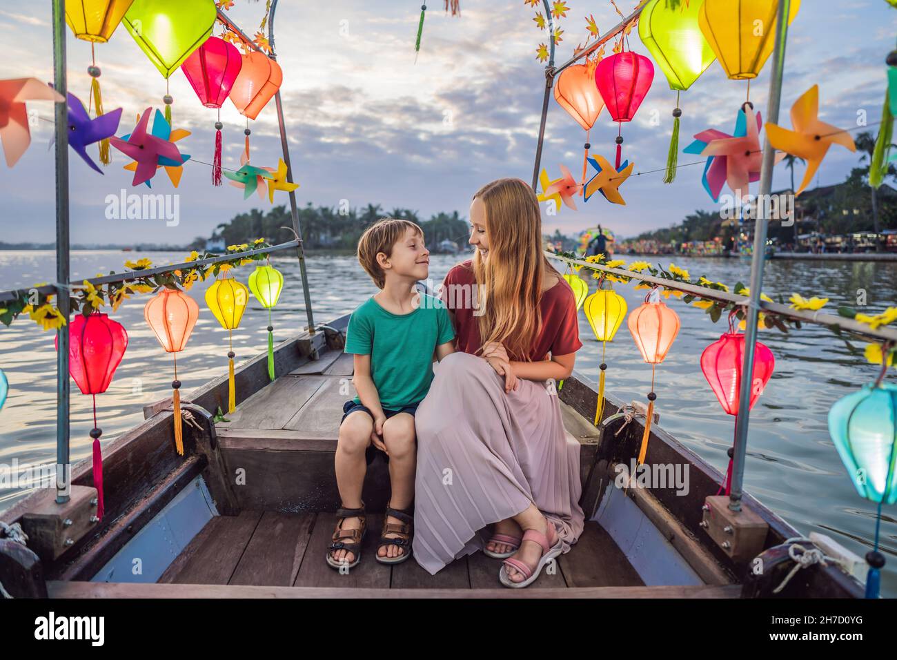 Happy family Mother and son of travelers ride a national boat on ...
