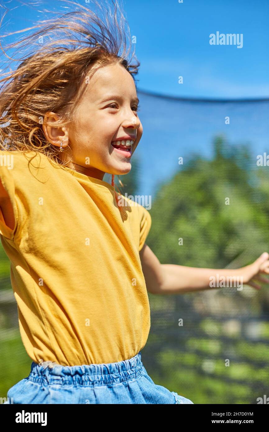 Little girl jumping up and down in hires stock photography and images