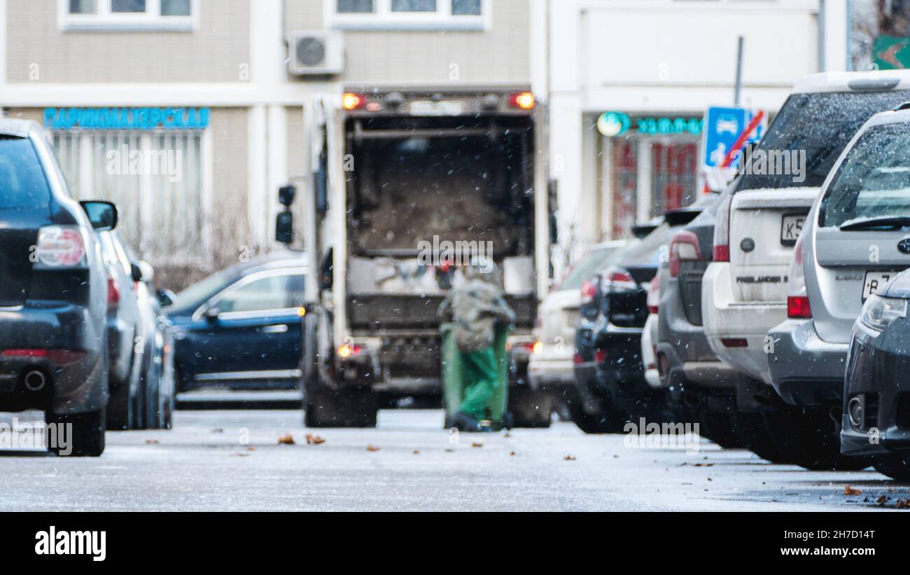 Garbage truck, dustcart with bin lift, household waste removal in residential area in winter, Moscow, 22 Nov 2021 Stock Photo