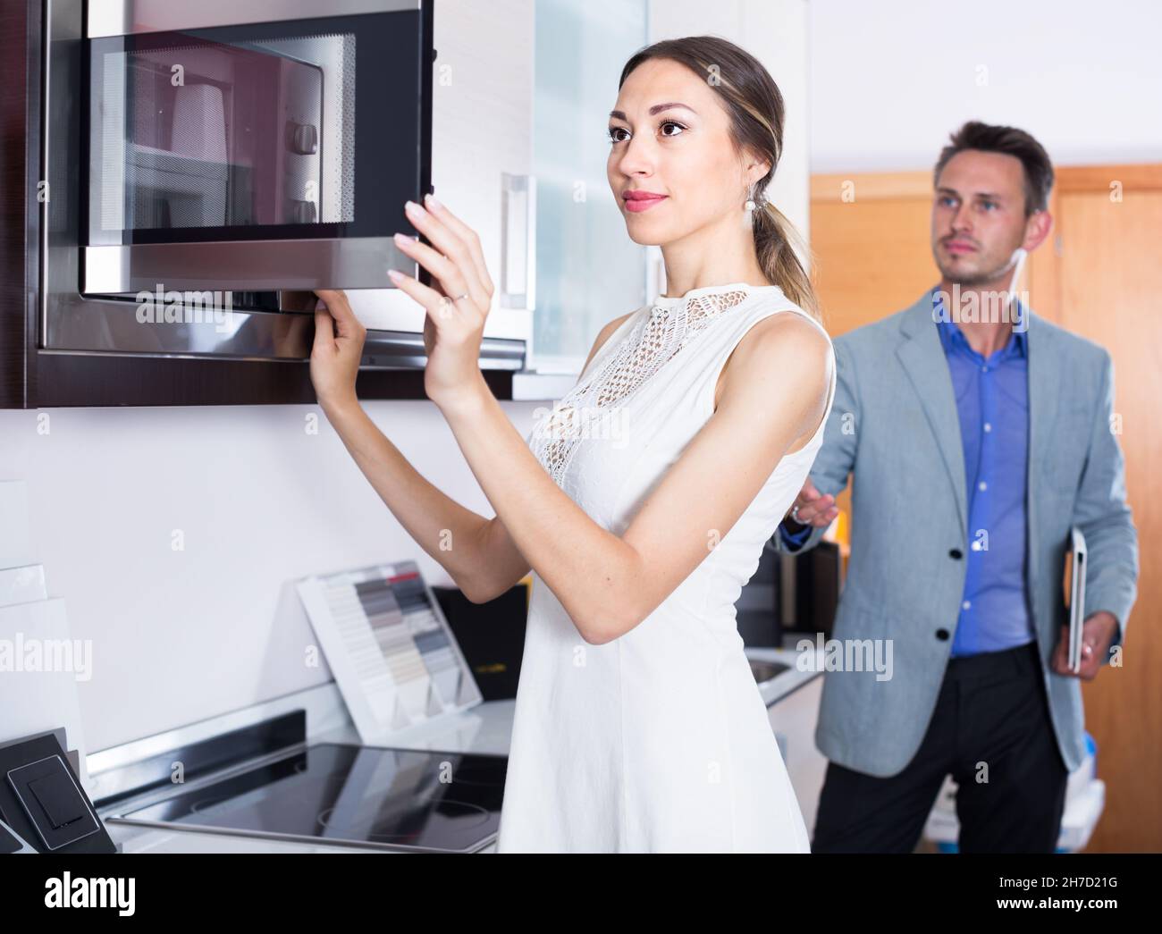 Young couple is choosing new microwave Stock Photo