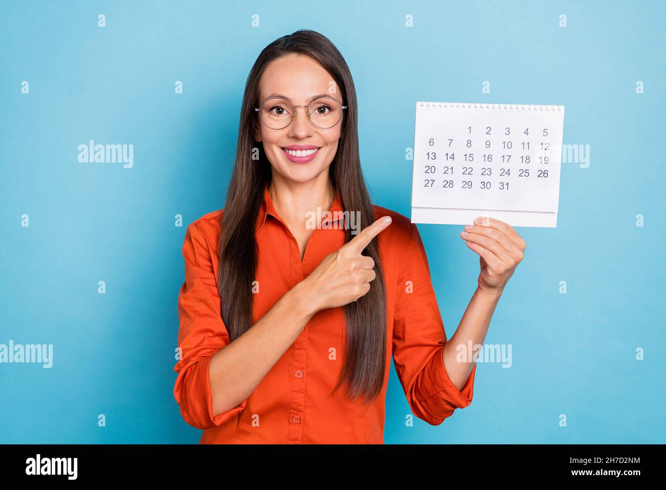 Photo of confident shiny young woman wear red shirt arm spectacles pointing  finger date planner smiling isolated blue color background Stock Photo -  Alamy