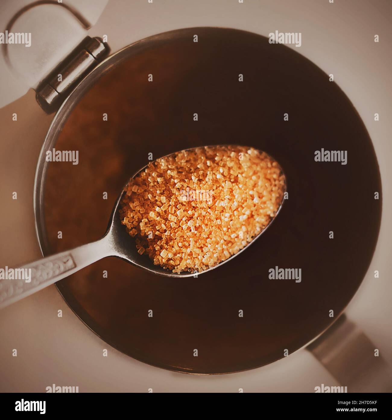 Top view of an elegant teaspoon with patterns, in which a portion of