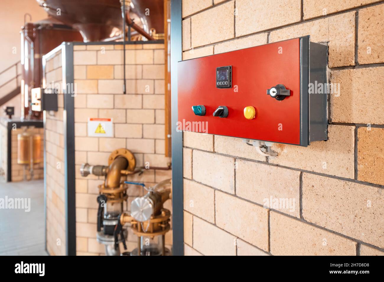 Red control panel with toggle switches and indicator of temperature and pressure in tanks and pipeline in a modern factory or plant Stock Photo