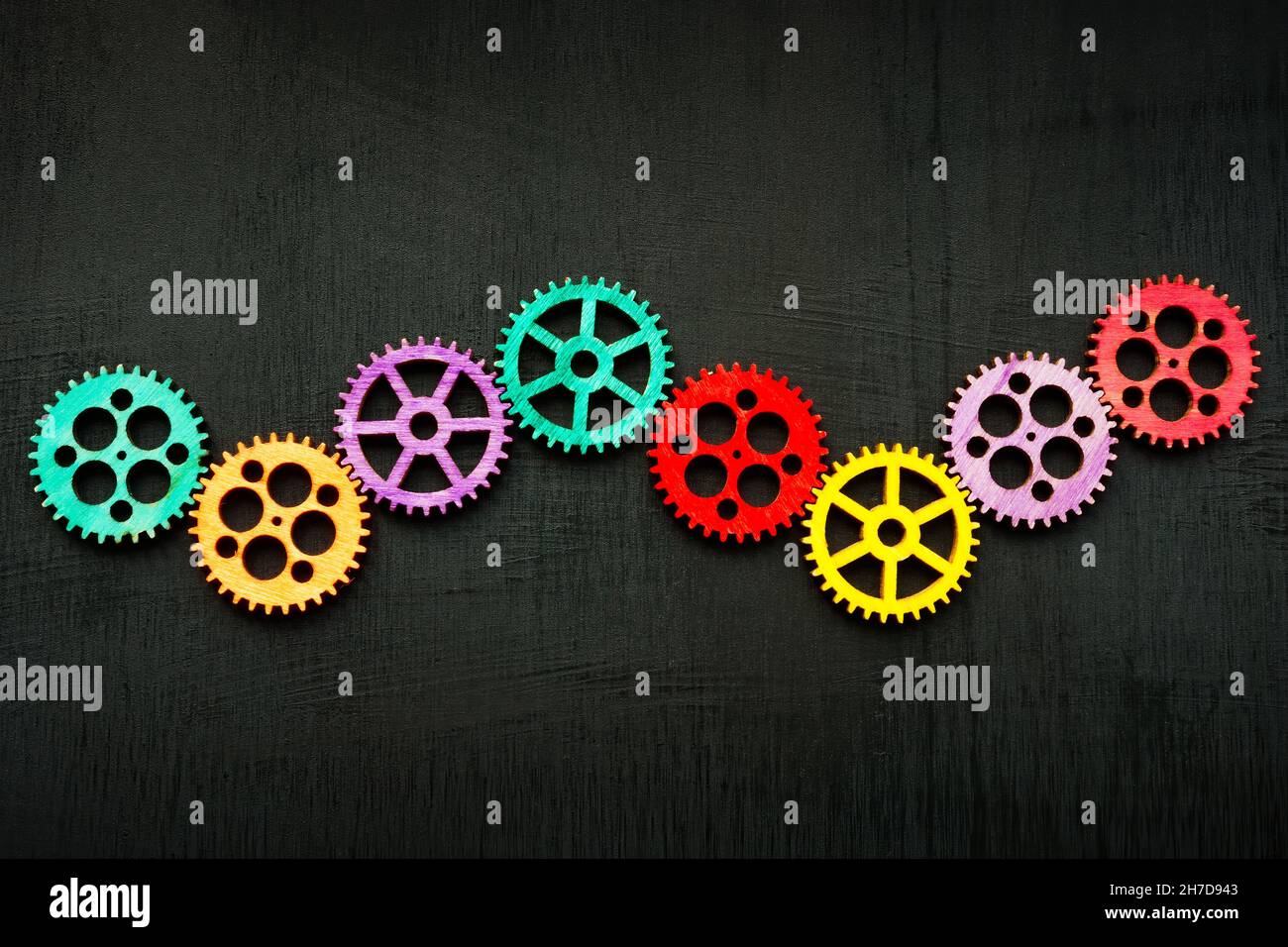 Line of colored gear wheels as symbol of teamwork and creativity. Stock Photo