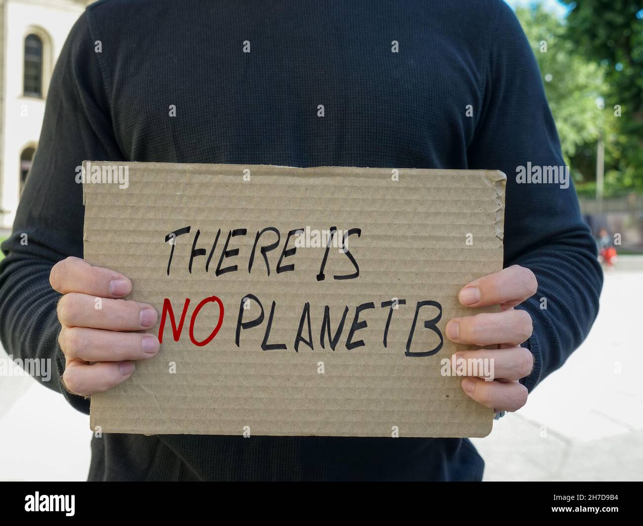 A man holds a poster There is no planet B. Stock Photo