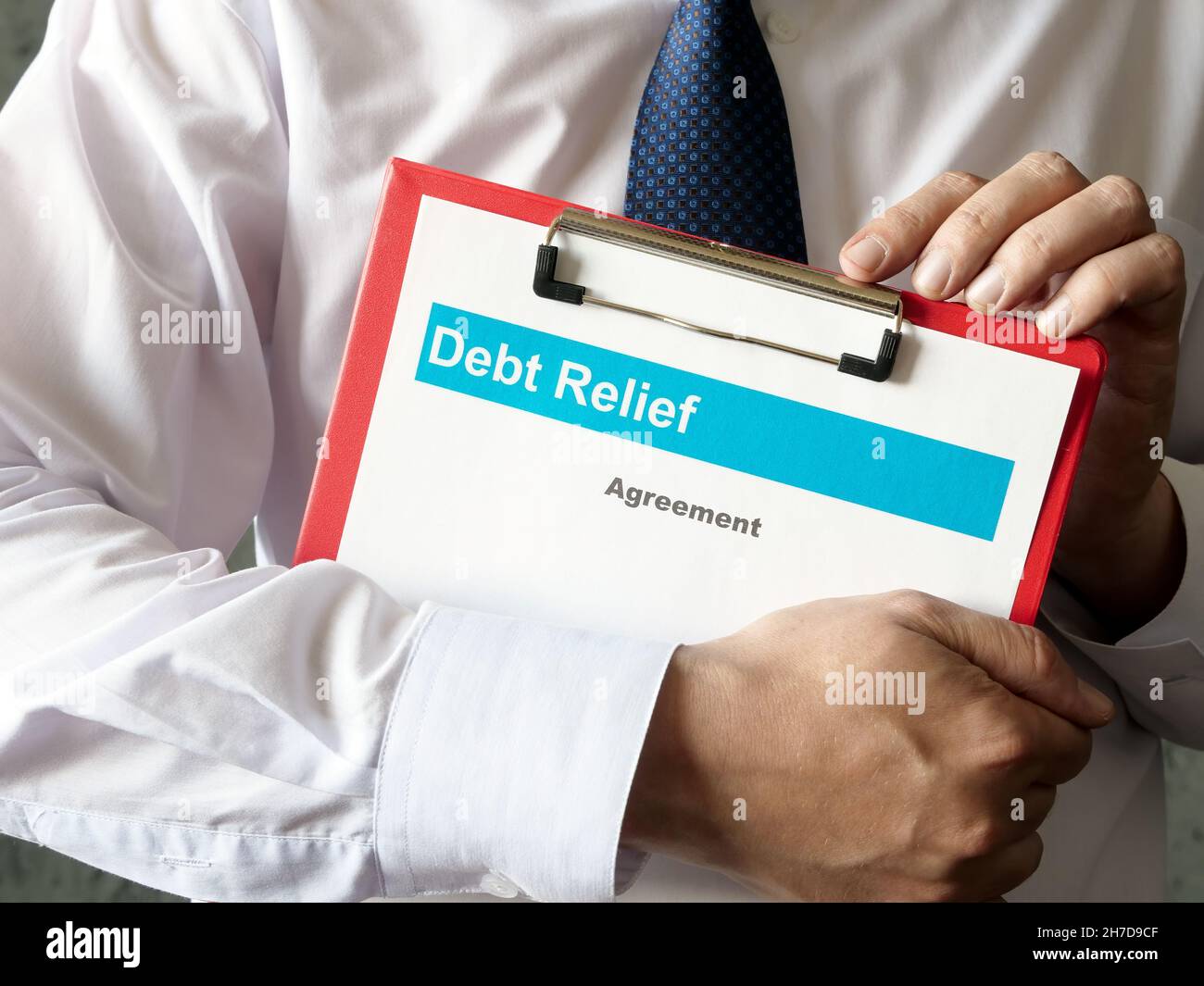 The banker holds the Debt relief agreement. Stock Photo