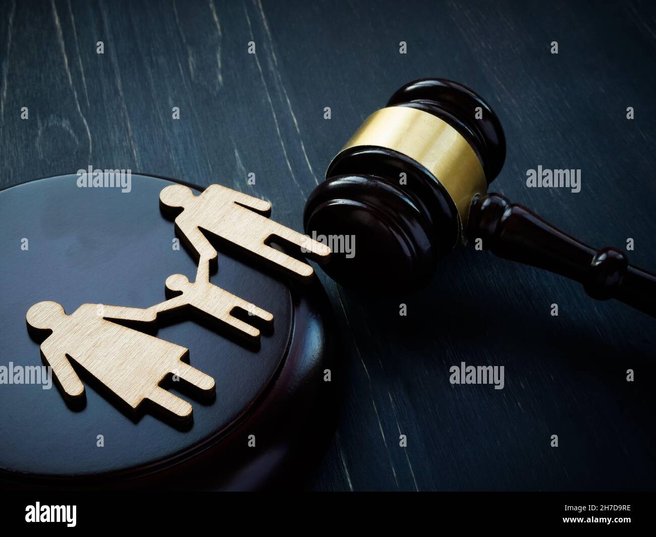 Family figurines and court hammer. Family law and adoption concept. Stock Photo