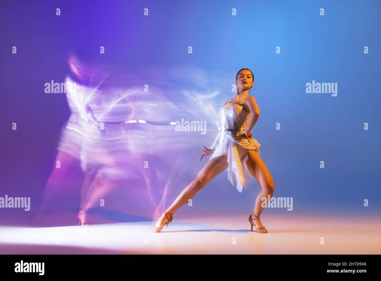 Portrait of young graceful flexible woman dancing ballroom dance