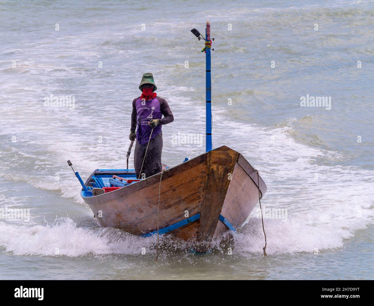 Small, wooden fishing boat near Map Ta Phut in the Rayong Province of Thailand. Stock Photo