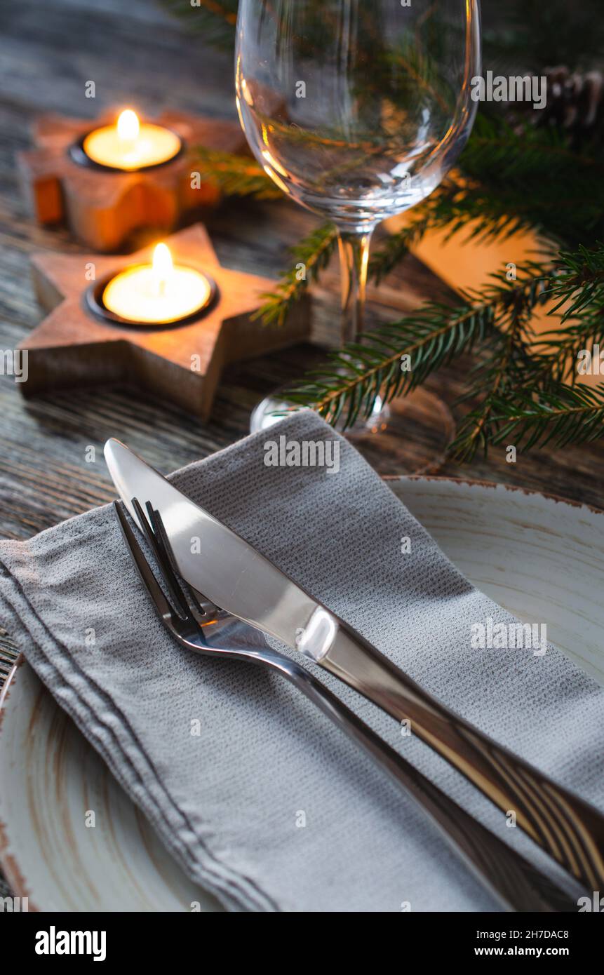 Cozy Christmas table setting with candles and fir branches Stock Photo ...