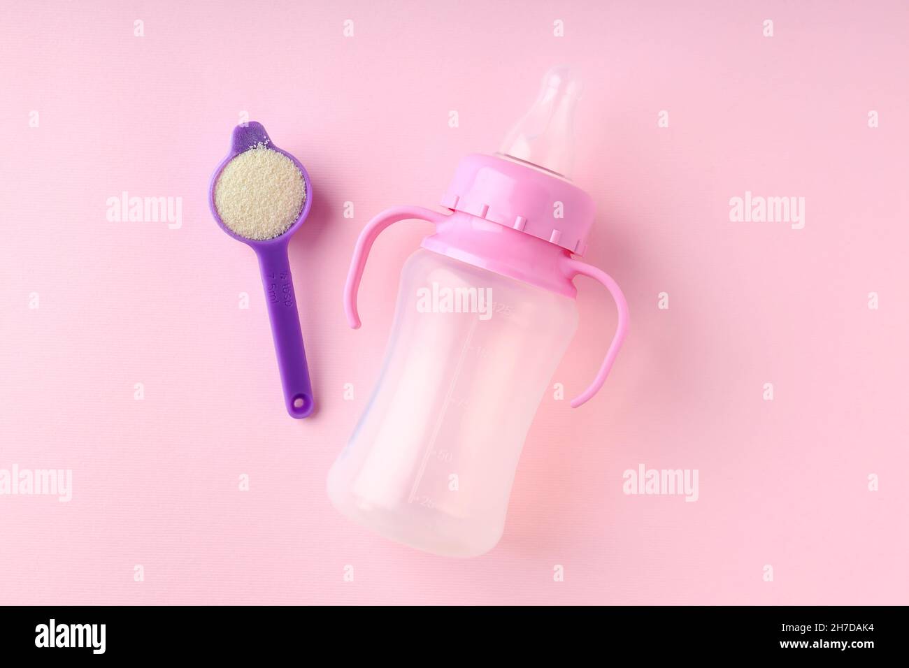 Concept of baby food with рowdered milk on pink background Stock Photo